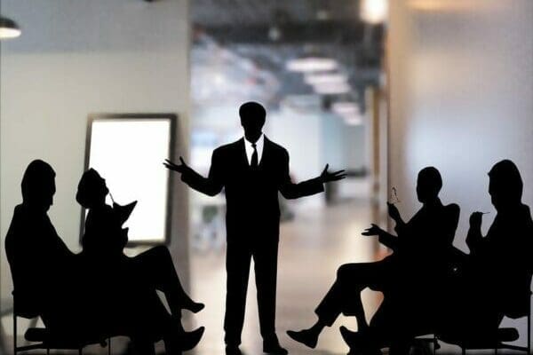 Black silhouettes of business people in a meeting