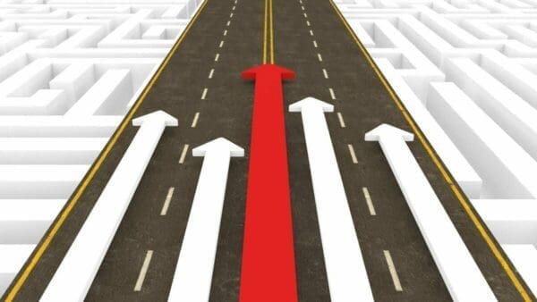 Red and white arrows on a four-lane road pointing forward represents higher achievement