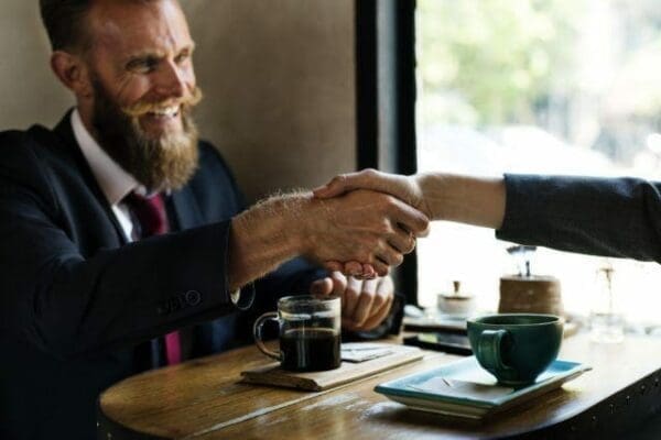 Male candidate shaking hand with recruitment agency interviewer