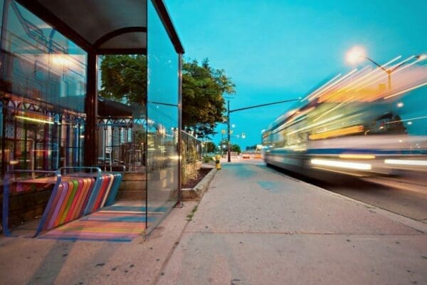 Blurred image of a bus passing a bus stop