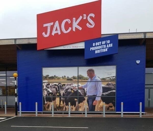 Jack's store with blue painted wall and farmer with cows
