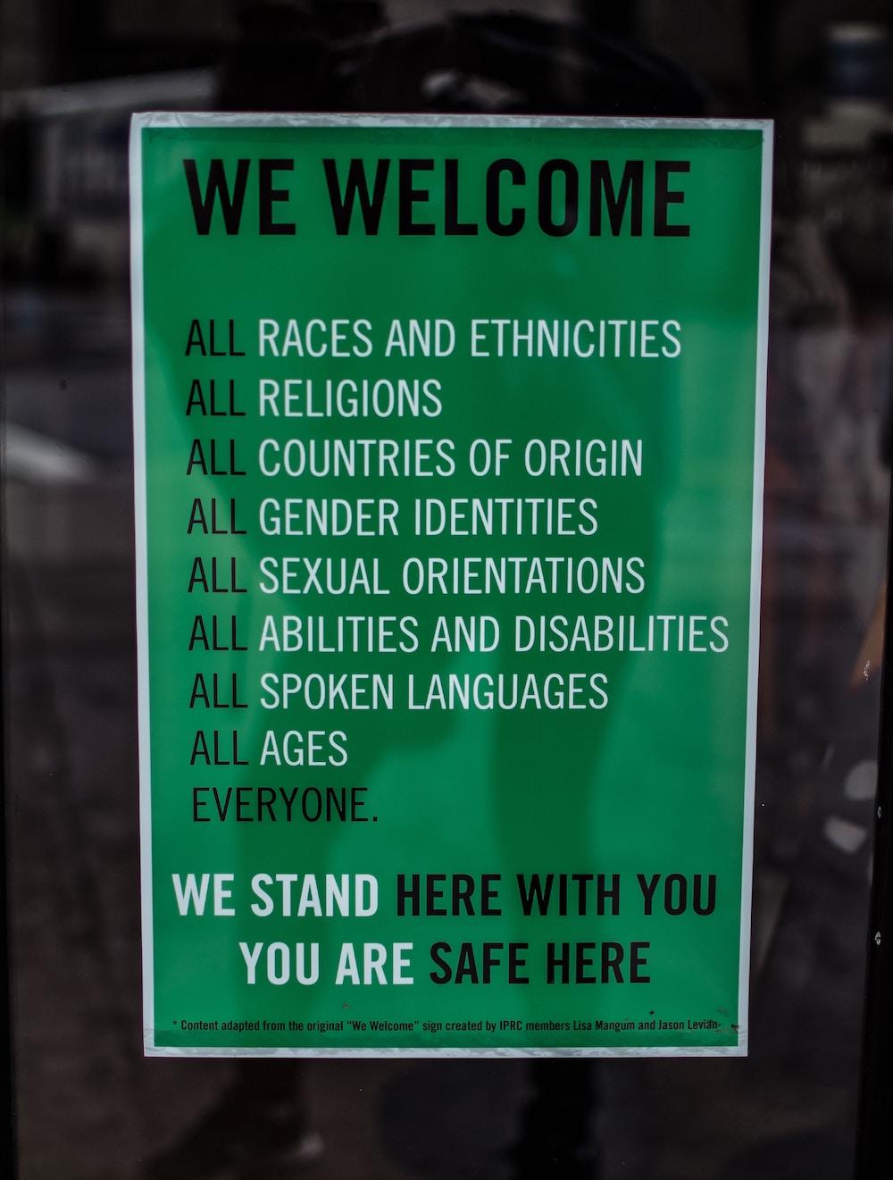 Green poster titled We Welcome to encourage inclusivity
