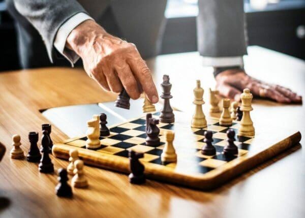Businessman playing chess using a strategy