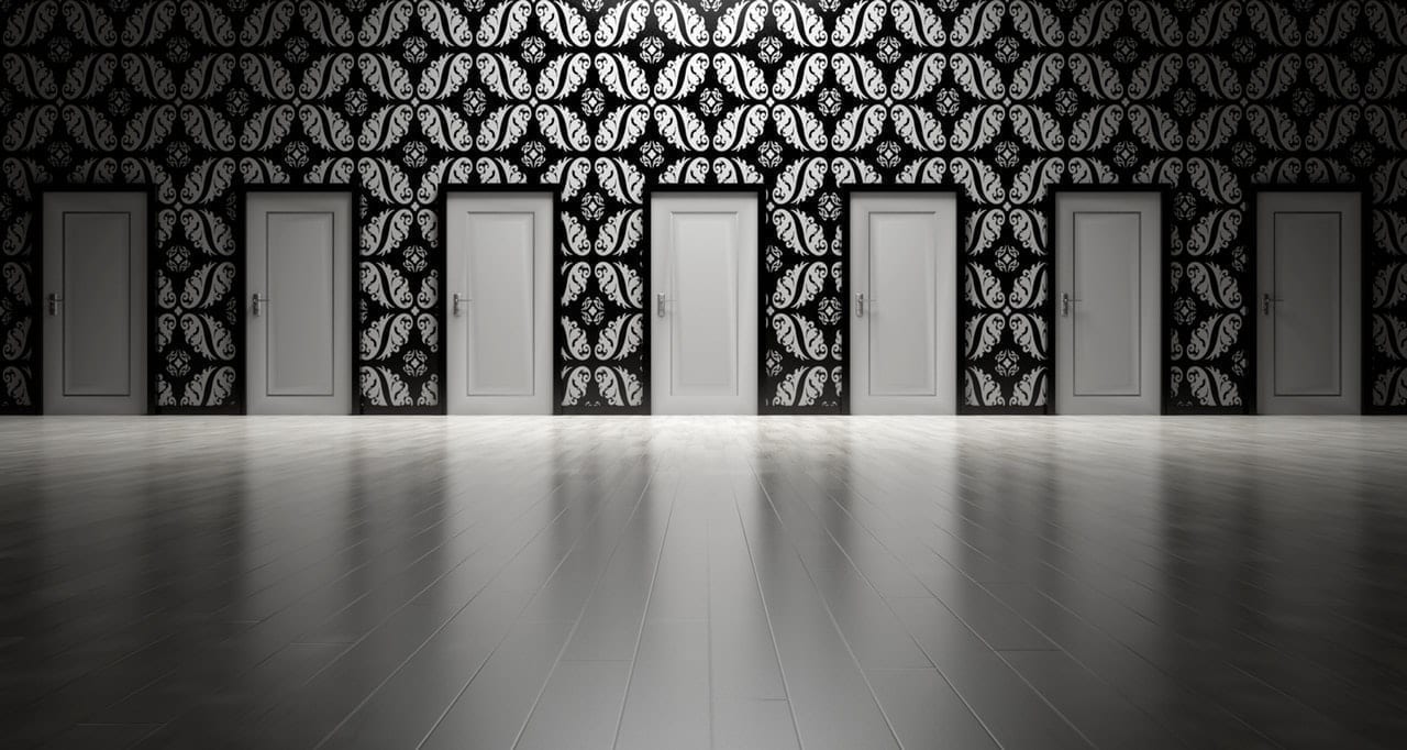 Series of white doors on a patterned wall