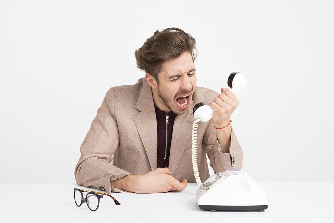 Angry businessman shouting into the phone