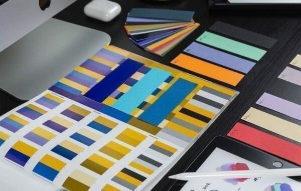 Pages of colour samples laid out on a desk 
