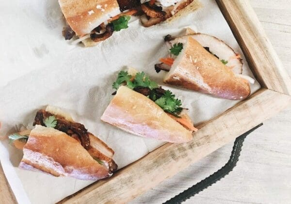 Five Lunch chicken Sandwiches served on a wooden board