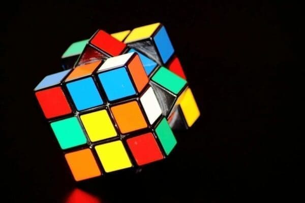 Colorful Rubik's cube on its axis on a black background