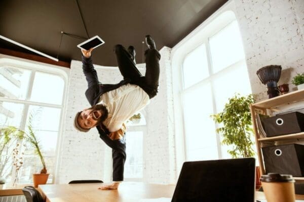 Businessman having fun break dancing while workng from home