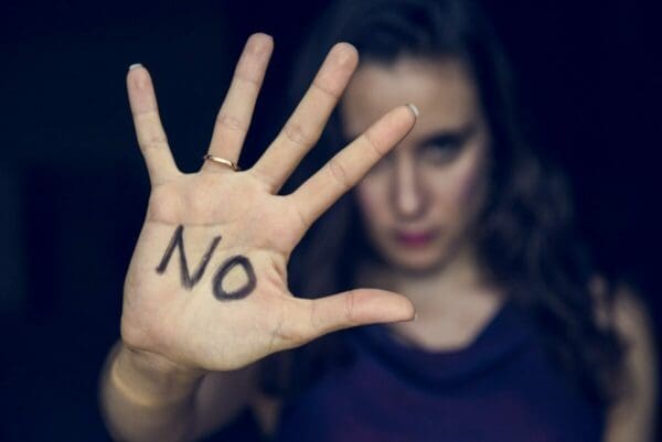 The word NO written on a woman's palm