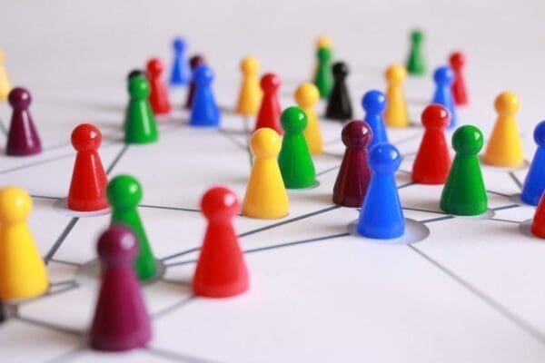Multi-coloured plastic counter pieces connected by lines represents networking