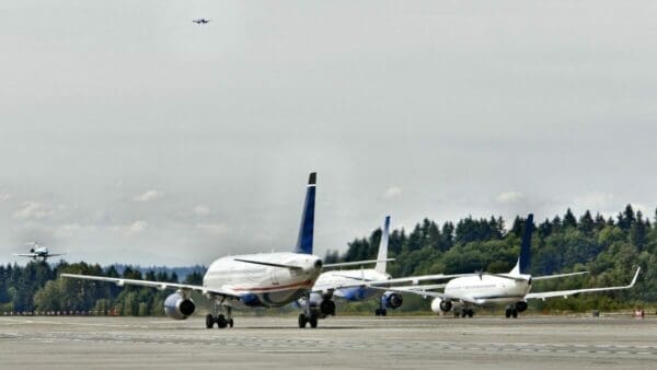Three airplanes on a runway at an airfield
