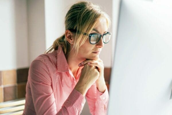 Woman wearing glasses concentrating on her computer screen