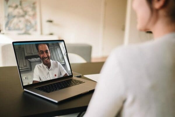 Two people having a video call on a laptop