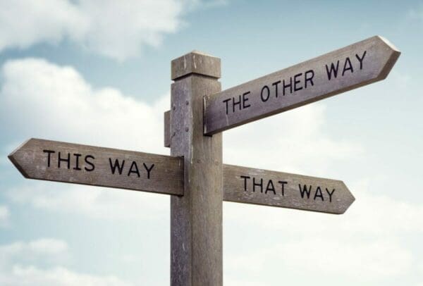 A crossroad sign of different ways, 'this way', 'that way' and 'the other way' for decision making Internal Conflict