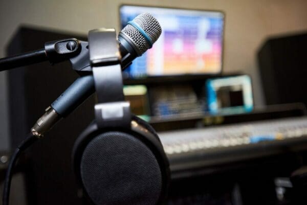 Microphone and headphones in studio with computer in the background