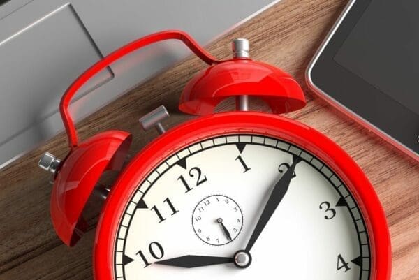 Close up of red alarm clock for time management