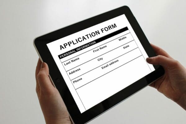 Job application form on electronic table 