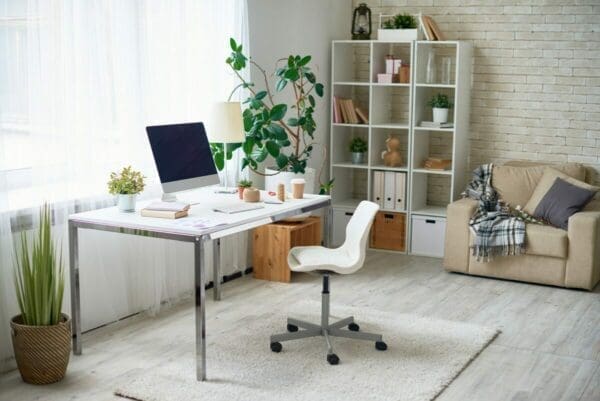 Perfect work from home office with plants, laptop, desk, chair and clean distraction-free area