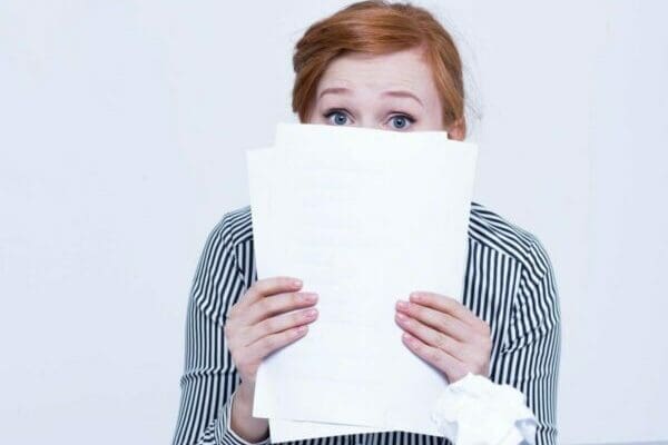 Woman hiding behind the papers