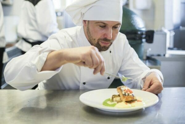 Chef putting the finishing touches on a dish is a perfectionist