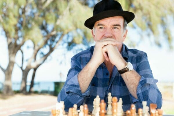Man with chessboard looking into the distance