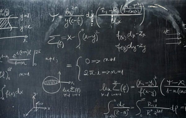 Blackboard with chalk drawings of mathematical equations
