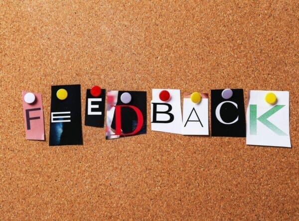 Feedback spelled with cut out of magazine letters on a pinboard