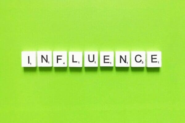 The word Influence spelt out using Scrabble tiles - Influencing Skills