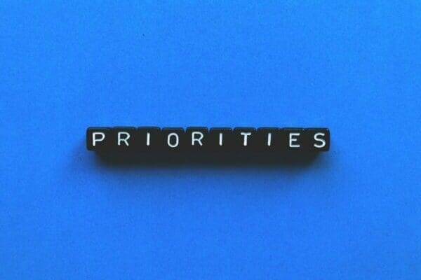 Priorities spelt out in black tiles on blue background