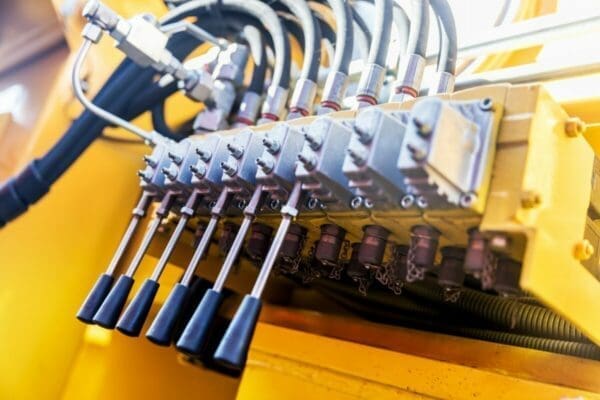 Row of levers on a yellow machine