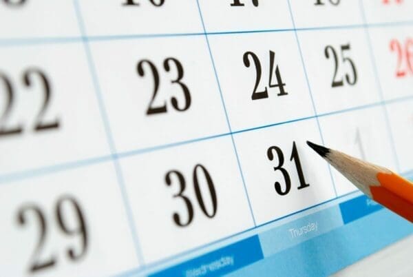 Pencil pointing to calendar date for sheduling next one-to-one meeting