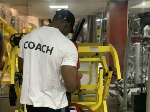 Coach in gym with coach t-shirt on