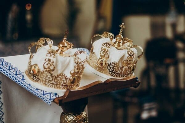 Two gold royal crowns on a table