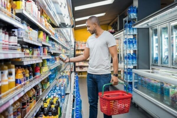 Account manager browsing supermarket shelf for information