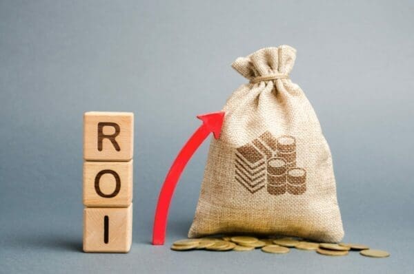 Wooden blocks with the word ROI and moneybag