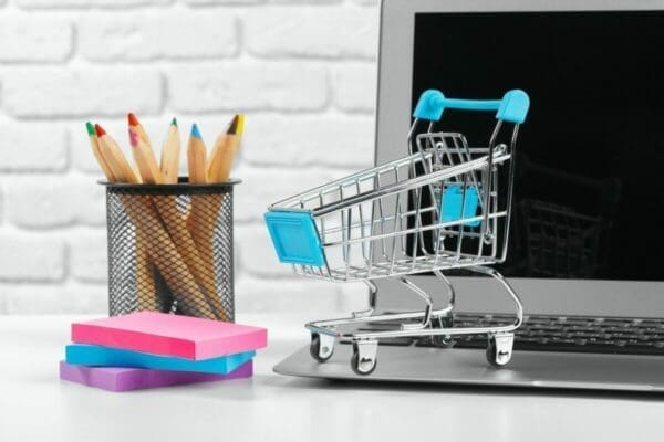 Shopping Online Concept : Mini Shopping Cart and Laptop
