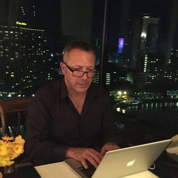 Picture of Riad Beladi Co Founder of OISA at his laptop at a desk
