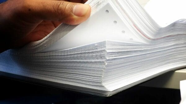Pile of papers to show paper trail from excessive communication