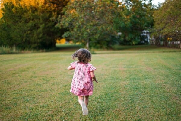 Back of a girl toddler running away