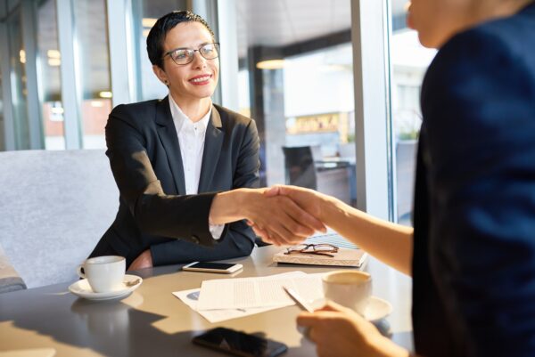 2 business people shaking hands after a negotiation 