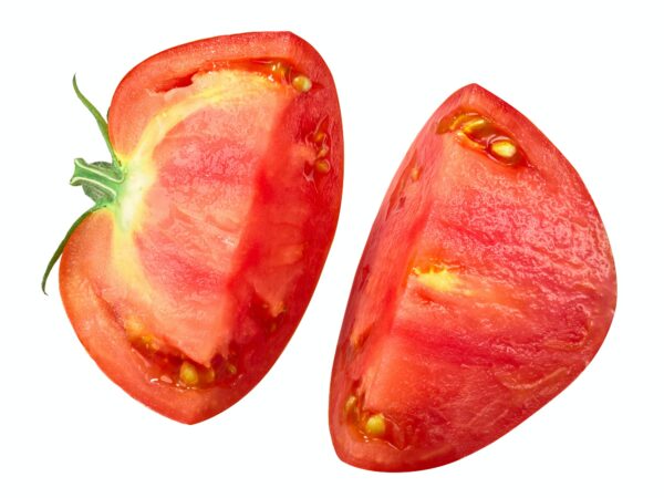 A tomato split into two on white background