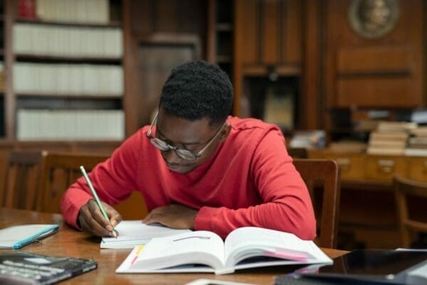 Student in library studying for CIPD exam