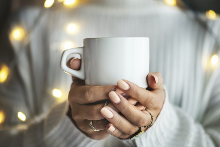 Woman's hands holding cup of tea