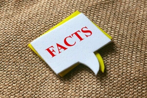 Facts speech bubble on brown cloth background
