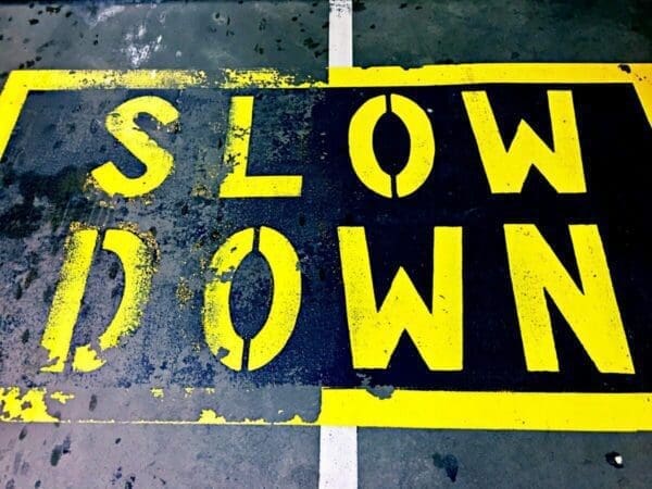 'SLOW DOWN' sign painted on the ground