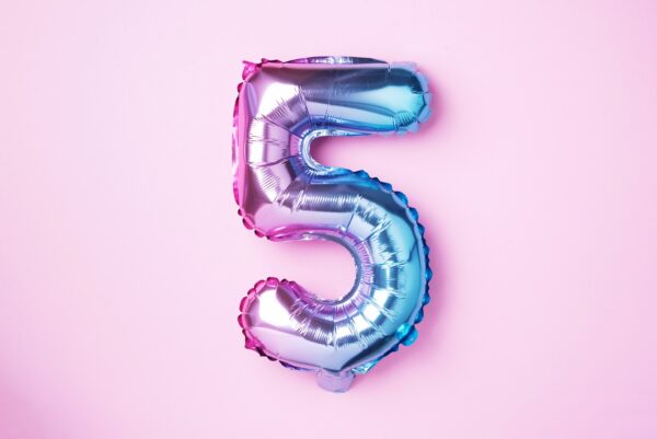 Creative layout. Rainbow foil balloon number and digit five 5.