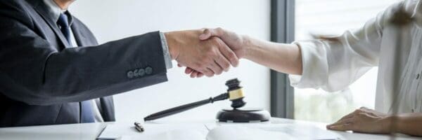 Male lawyer and business customer handshake after deal agreement