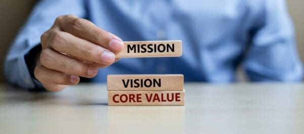 Mission, Vision and Core Value blocks with businessman in the background