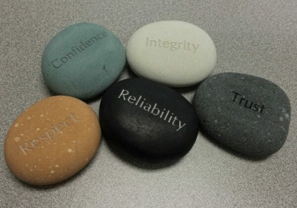 coloured stones with different company values written on them 